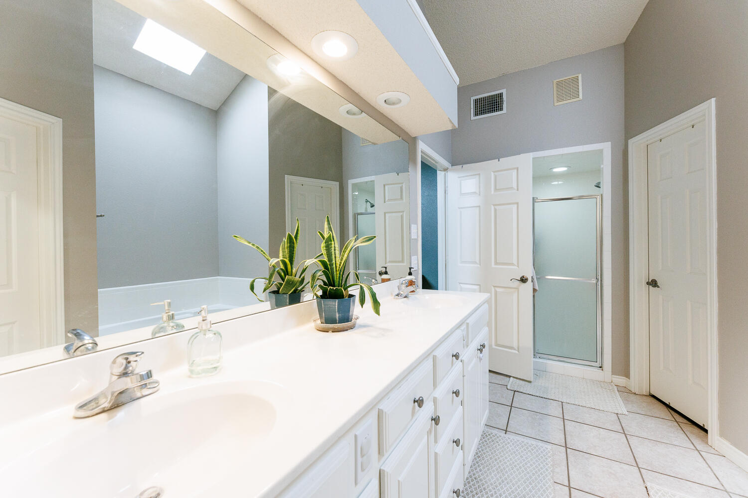 5504 101st Street Lubbock, TX 79424 - Photo 31 of 50 a bathroom with a double vanity sink mirror and shower