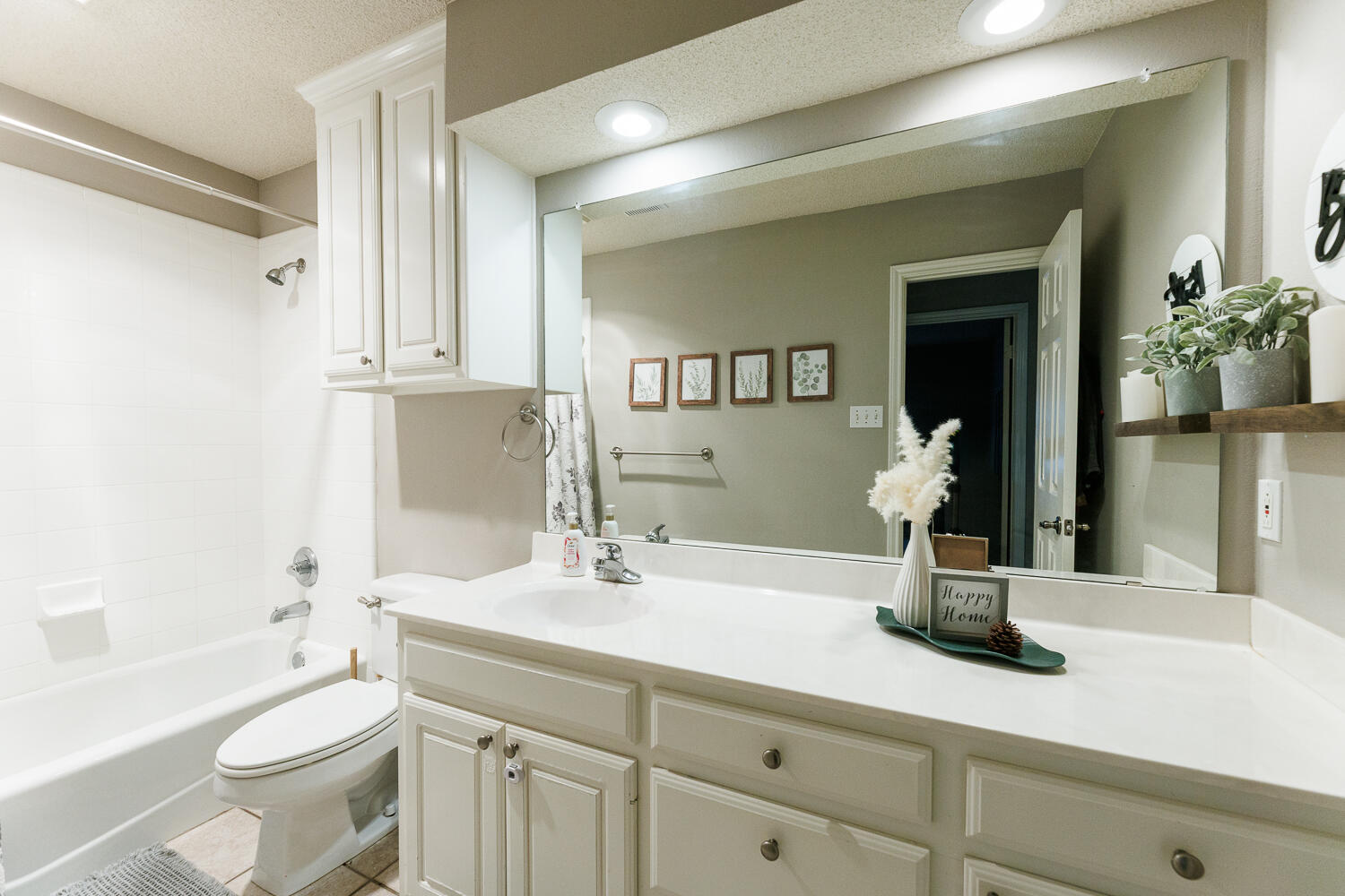 5504 101st Street Lubbock, TX 79424 - Photo 39 of 50 a bathroom with a double vanity sink toilet and shower