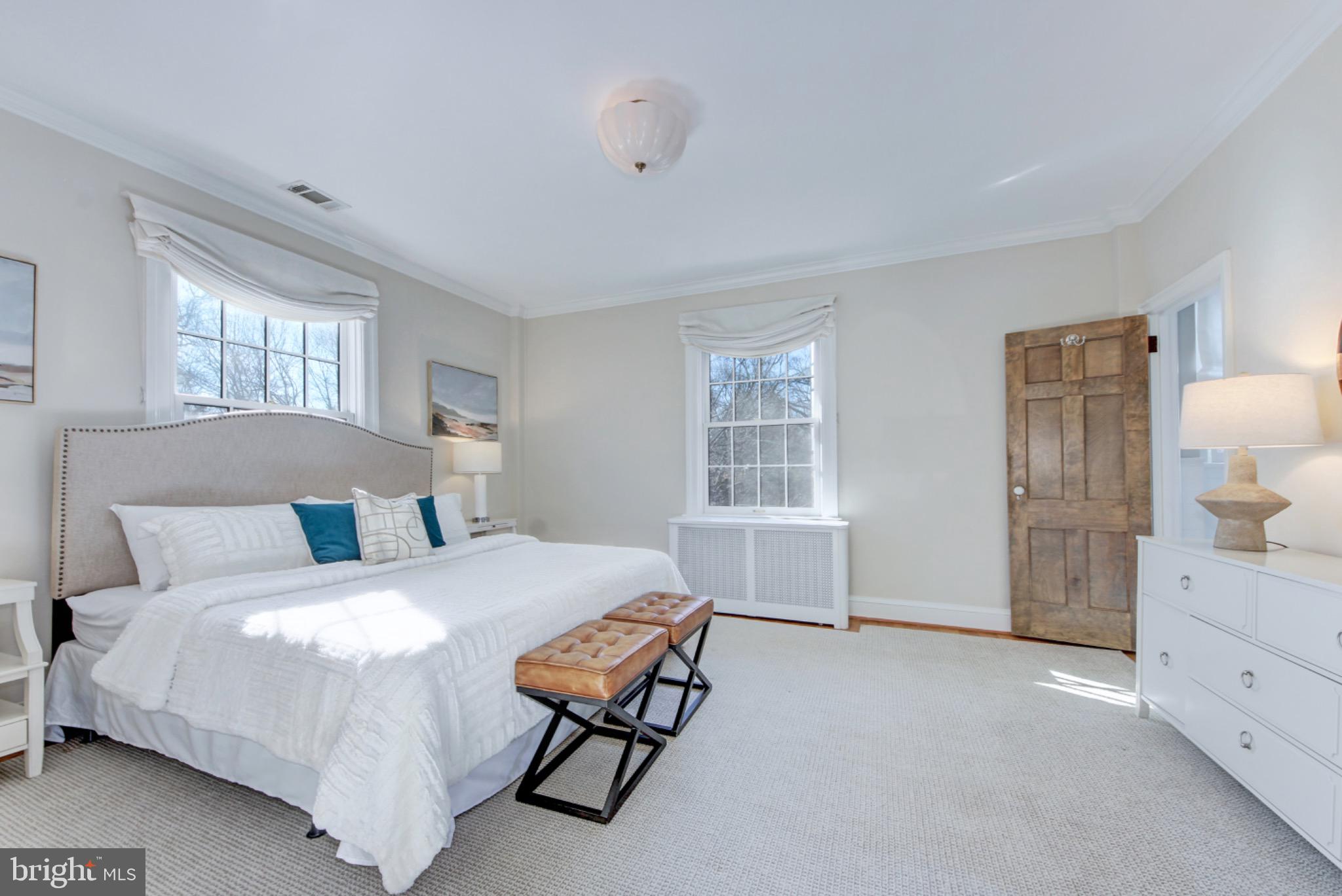 3000 Tilden Street Northwest, Unit 501I Washington, DC 20008 - Photo 17 of 48 a bedroom with a bed and a dresser next to a window