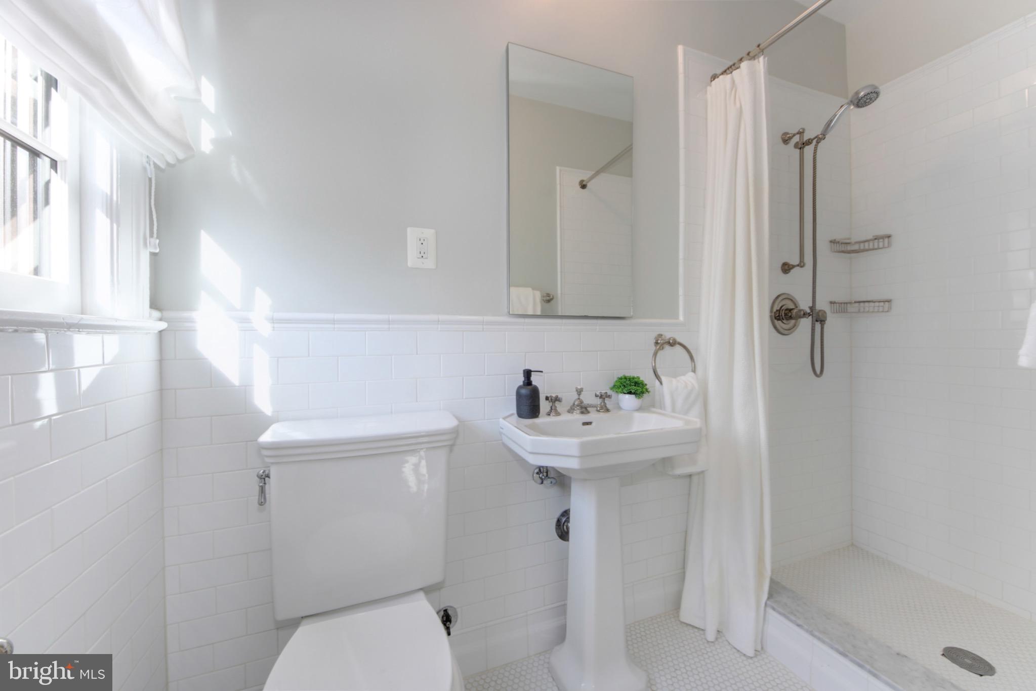 3000 Tilden Street Northwest, Unit 501I Washington, DC 20008 - Photo 18 of 48 a bathroom with a sink a toilet and shower