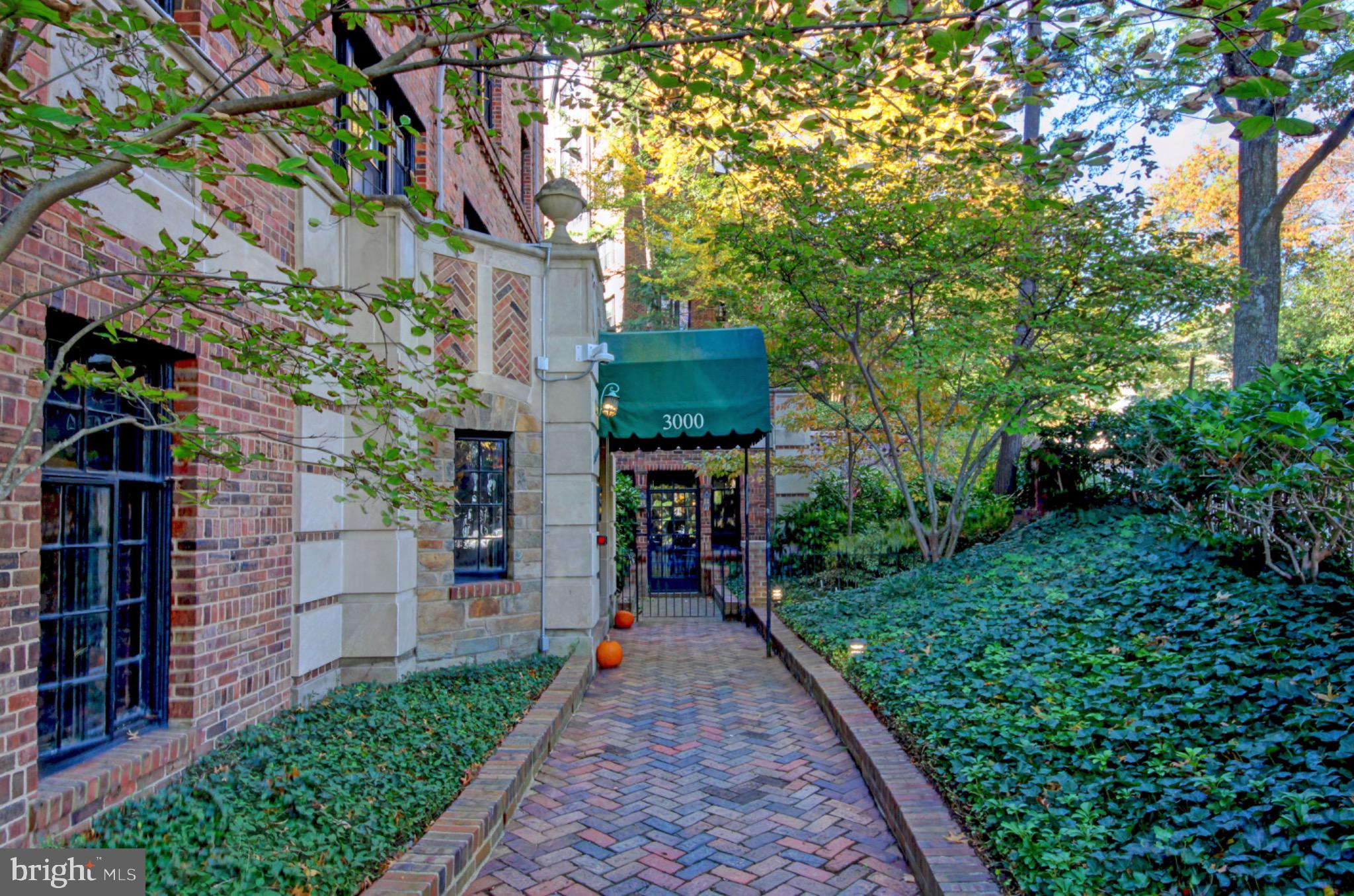 3000 Tilden Street Northwest, Unit 501I Washington, DC 20008 - Photo 30 of 48 a front view of a house with a yard