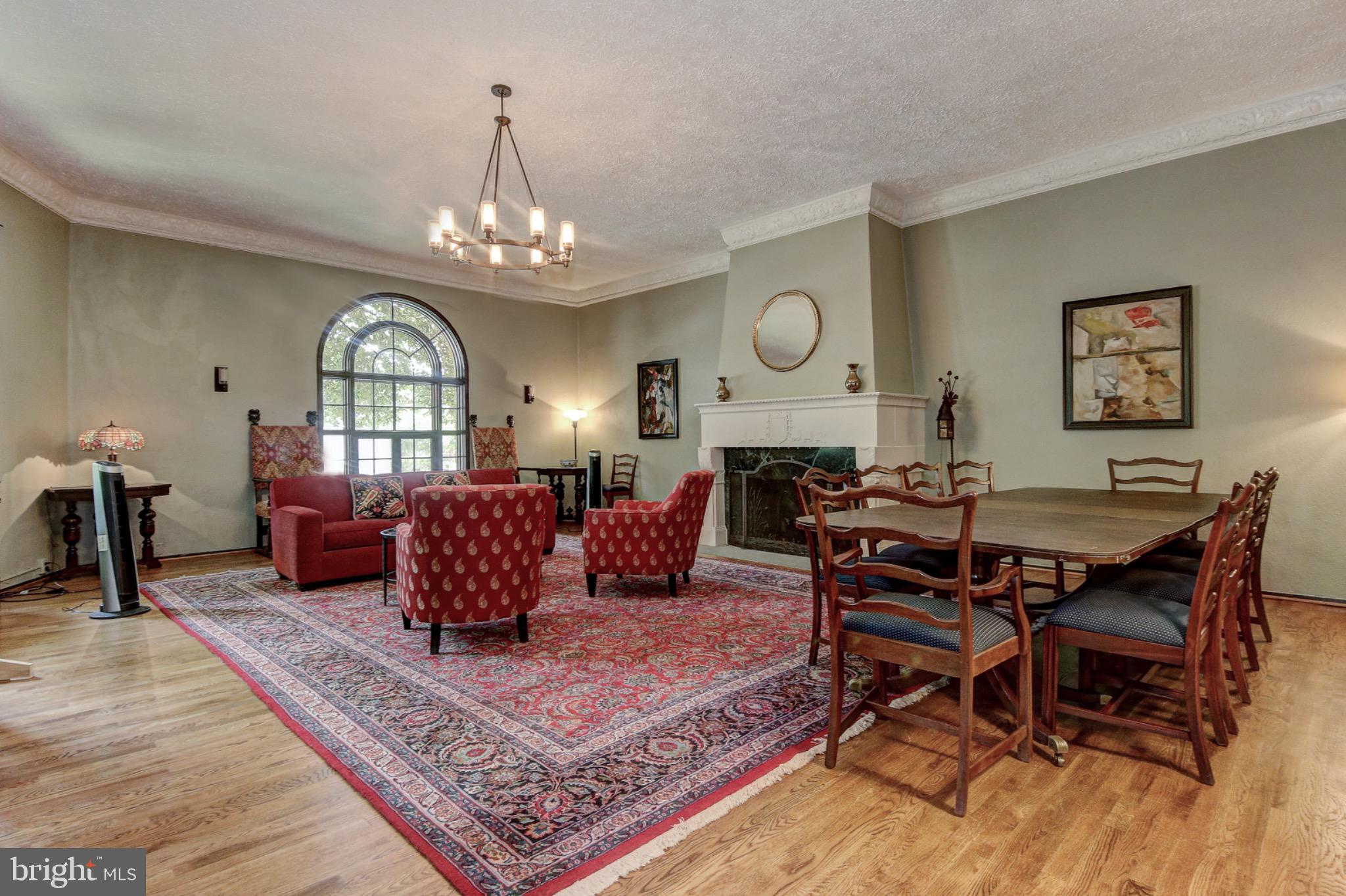 3000 Tilden Street Northwest, Unit 501I Washington, DC 20008 - Photo 32 of 48 a living room with furniture a chandelier a rug and a window