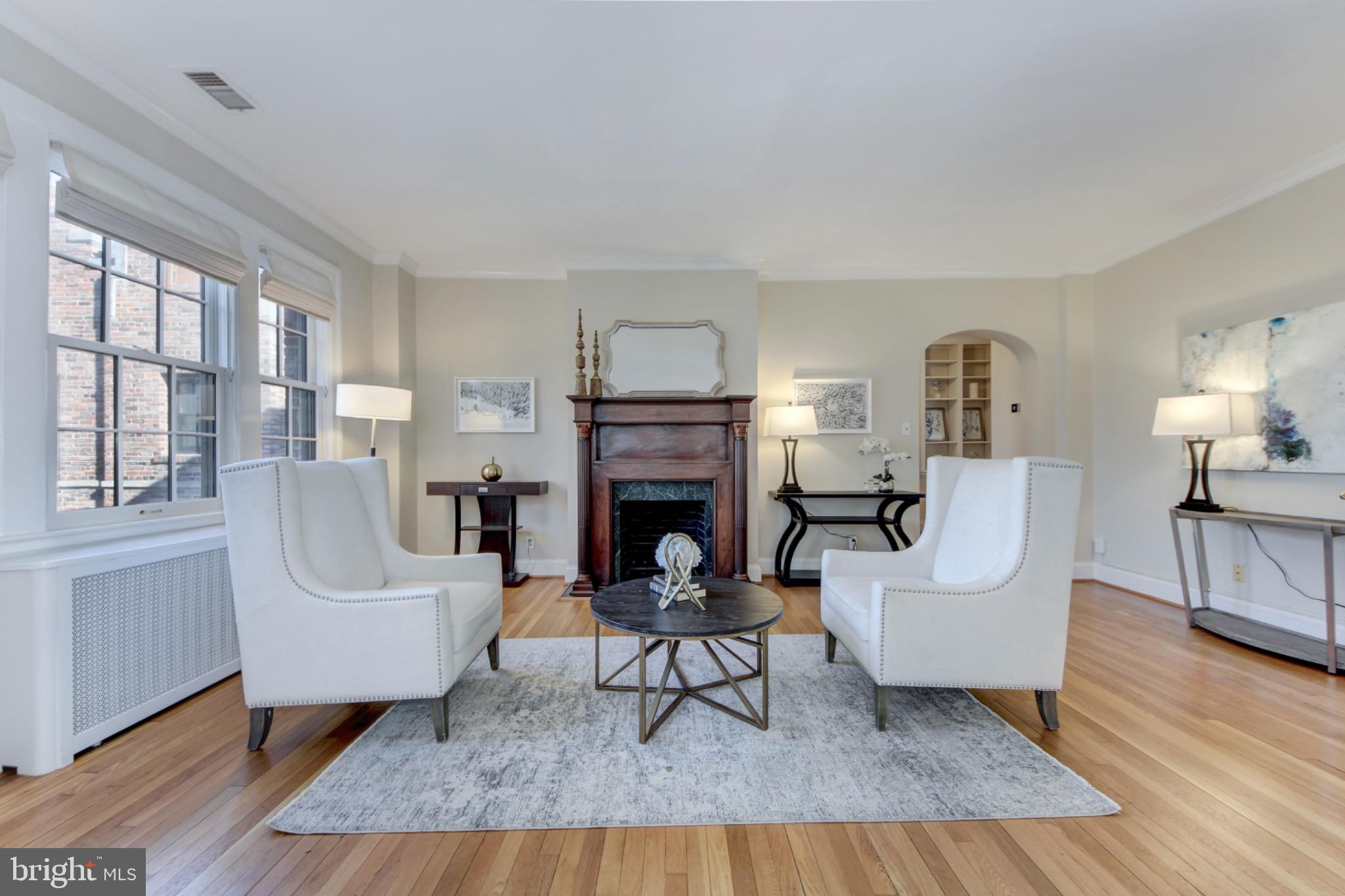 3000 Tilden Street Northwest, Unit 501I Washington, DC 20008 - Photo 4 of 48 a living room with furniture and a fireplace