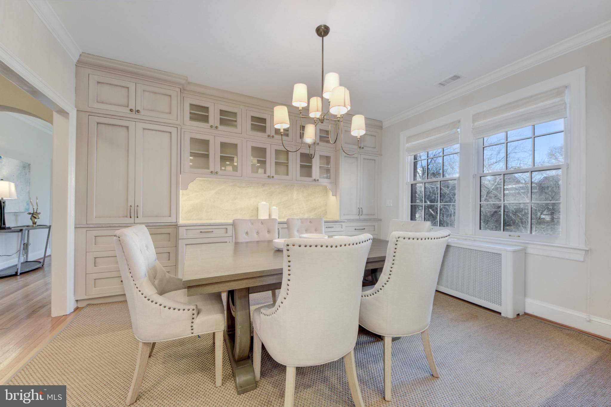 3000 Tilden Street Northwest, Unit 501I Washington, DC 20008 - Photo 9 of 48 a dining room with furniture a chandelier and window