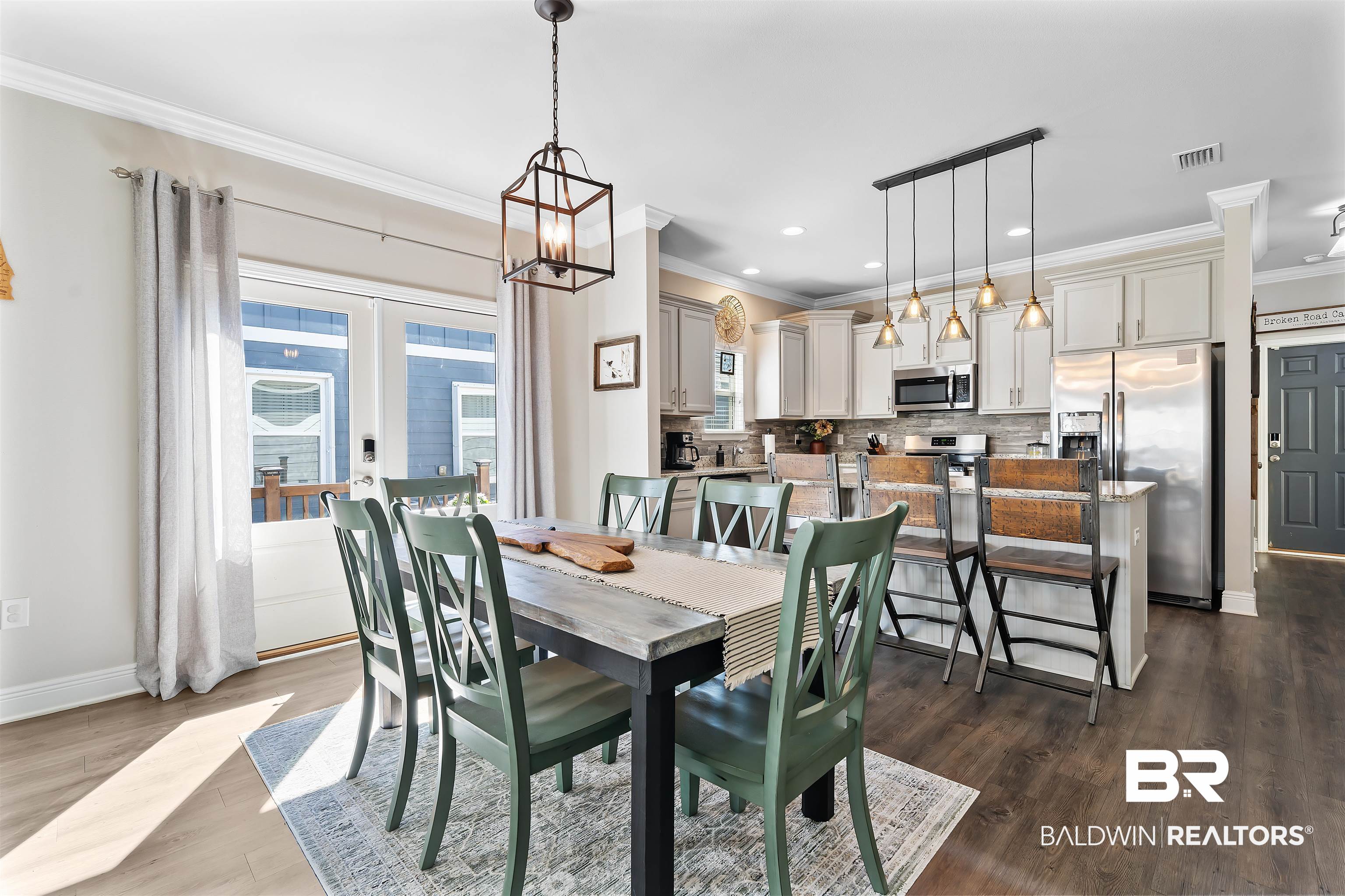 1221 Primrose Lane Foley, AL 36535 - Photo 21 of 29 Dining room featuring baseboards, visible vents, dark wood-type flooring, crown molding, and a chandelier