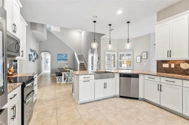 a bathroom with a granite countertop double vanity sink and a mirror