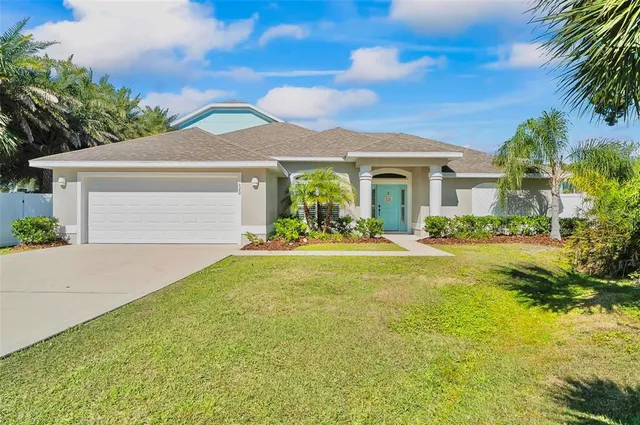 a front view of a house with yard and green space