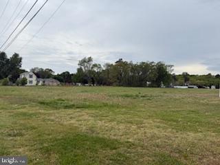 6850 Shawnee Road Milford, DE 19963 - Photo 4 of 15 a view of a field with grass and trees in the background