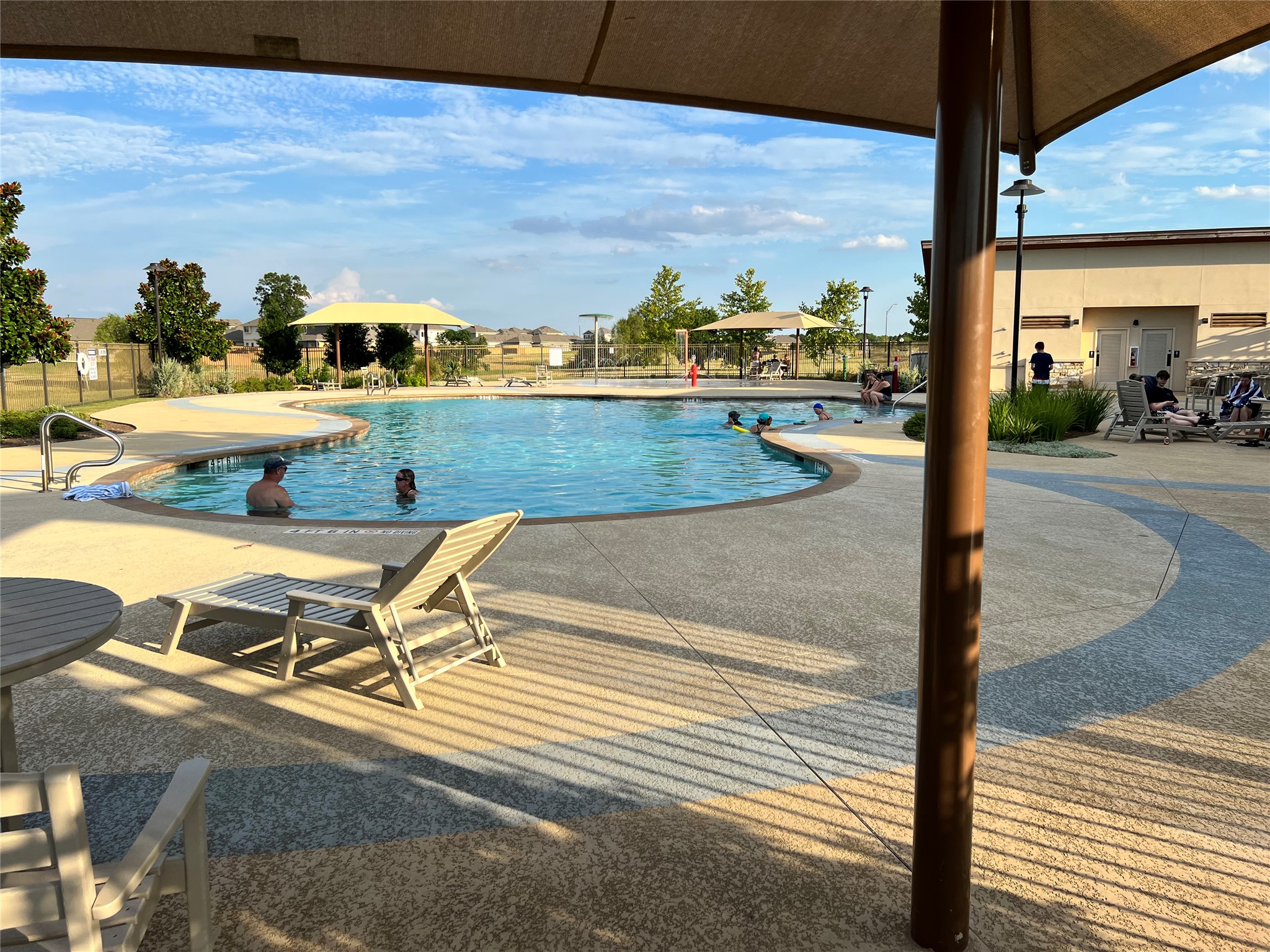 140 Pentro Path Georgetown, TX 78626 - Photo 27 of 37 Lounge poolside at the community's refreshing outdoor aquatic center.