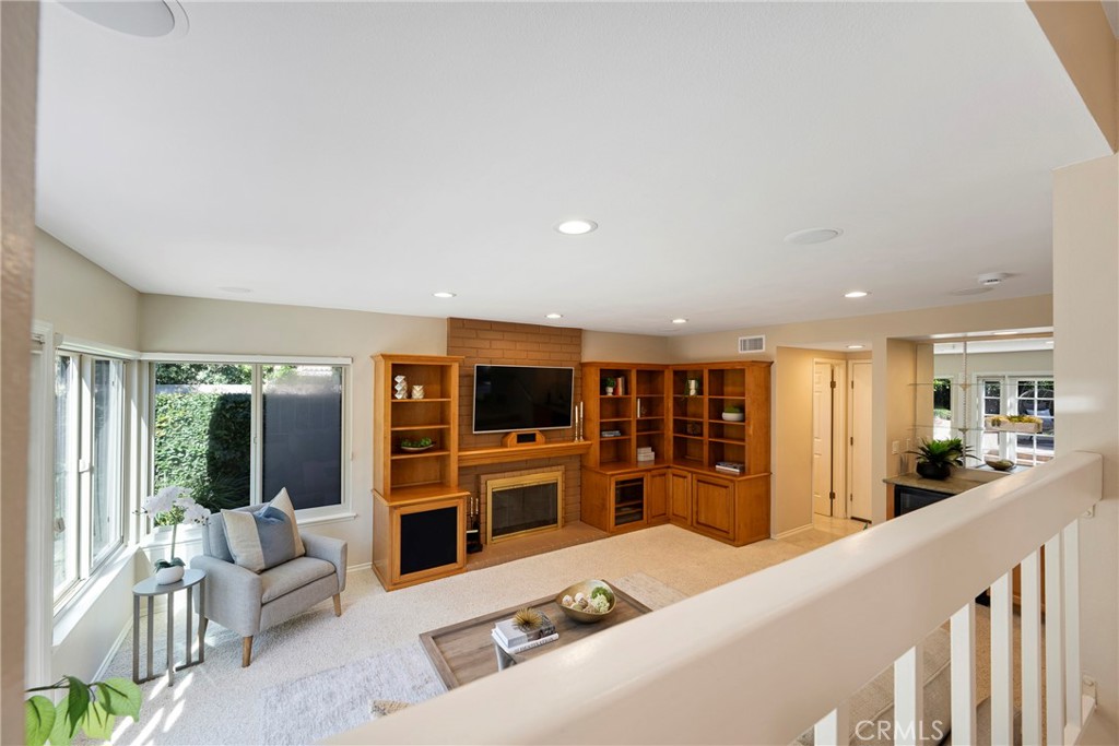 19 Ninos Irvine, CA 92620 - Photo 17 of 65 a living room with furniture a flat screen tv and a refrigerator