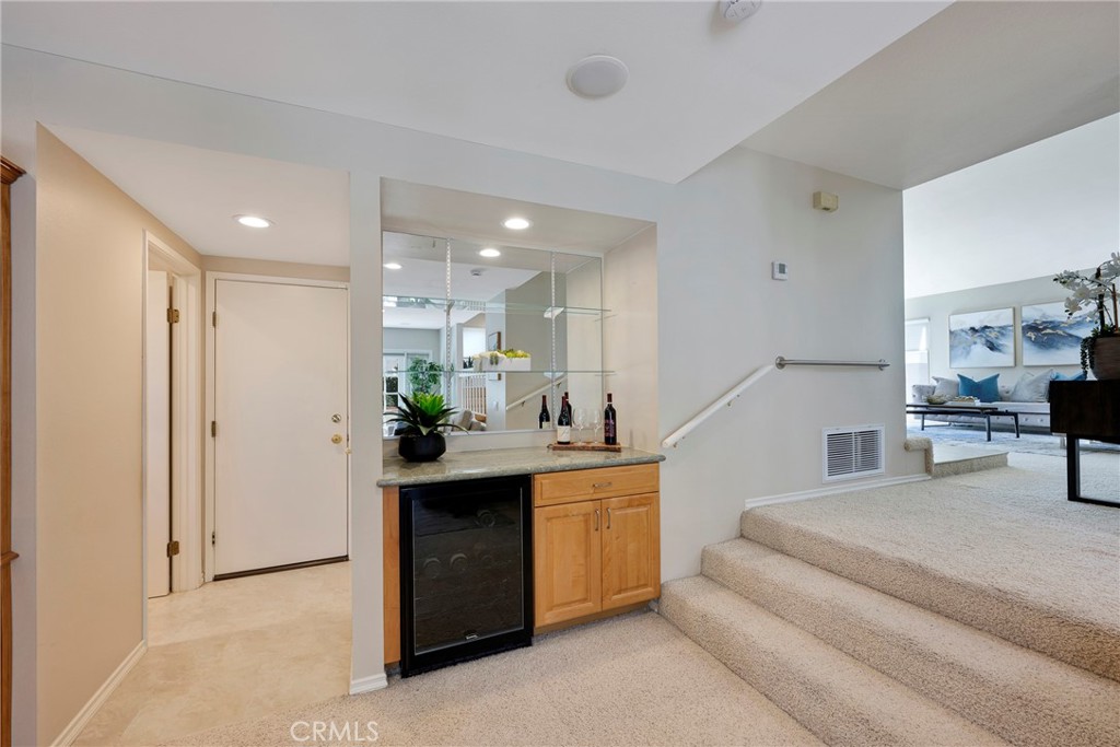 19 Ninos Irvine, CA 92620 - Photo 21 of 65 a living room with kitchen island furniture and a kitchen view