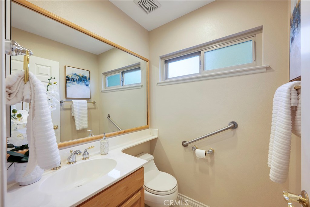 19 Ninos Irvine, CA 92620 - Photo 22 of 65 a bathroom with a sink vanity mirror and toilet