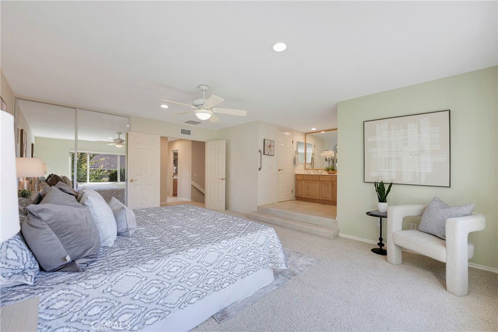 19 Ninos Irvine, CA 92620 - Photo 28 of 65 a spacious bedroom with a balcony a bed and a couch