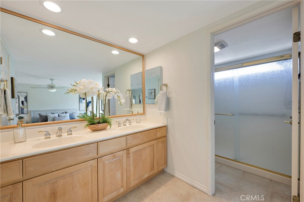 19 Ninos Irvine, CA 92620 - Photo 30 of 65 a bathroom with a double vanity sink and mirror