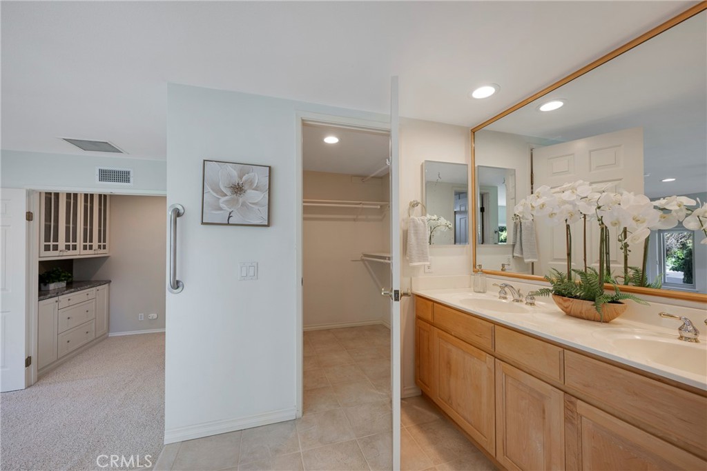 19 Ninos Irvine, CA 92620 - Photo 32 of 65 a bathroom with a double vanity sink mirror and shower