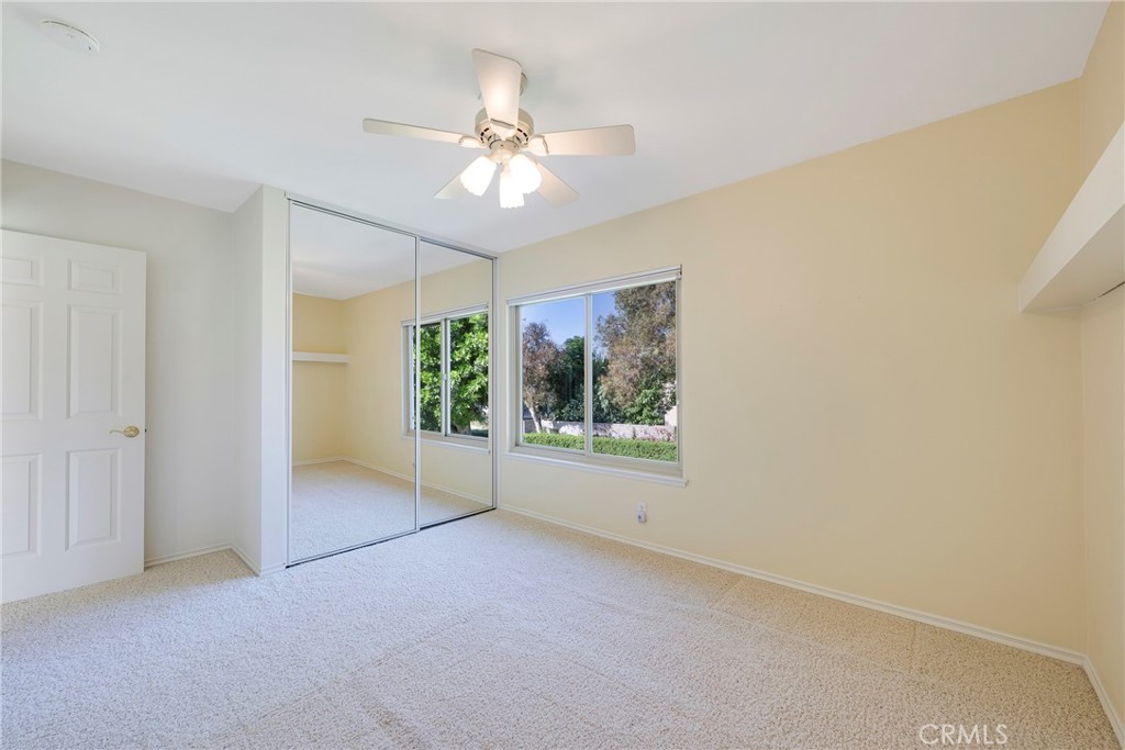 19 Ninos Irvine, CA 92620 - Photo 38 of 65 an empty room with windows and chandelier fan