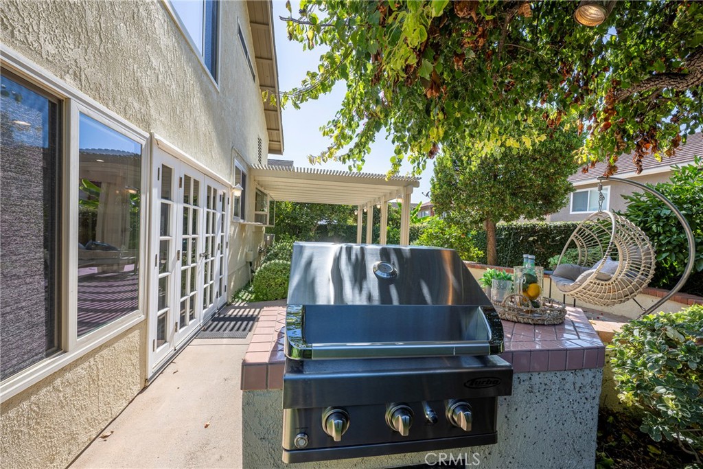 19 Ninos Irvine, CA 92620 - Photo 48 of 65 a view of a patio with table and chairs and potted plants