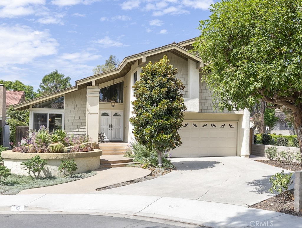 19 Ninos Irvine, CA 92620 - Photo 5 of 65 a front view of a house with garden and plants