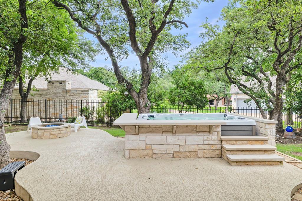 210 Mickelson Lane Georgetown, TX 78628 - Photo 11 of 39 a view of backyard with swimming pool and table and chairs under an umbrella