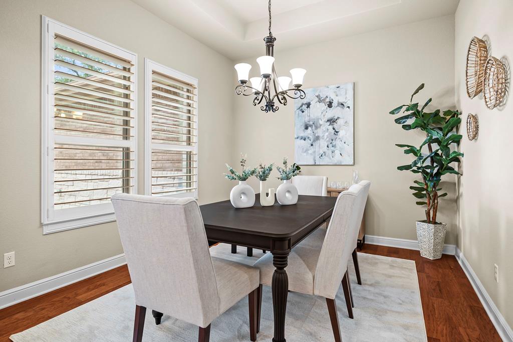 210 Mickelson Lane Georgetown, TX 78628 - Photo 17 of 39 a view of a dining room with furniture window and wooden floor