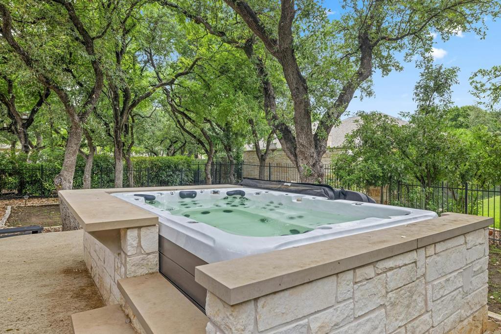 210 Mickelson Lane Georgetown, TX 78628 - Photo 30 of 39 a view of a backyard with a barbeque and large trees