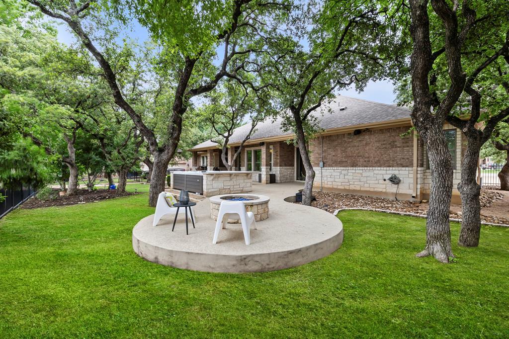210 Mickelson Lane Georgetown, TX 78628 - Photo 33 of 39 a view of a house with backyard and a fountain