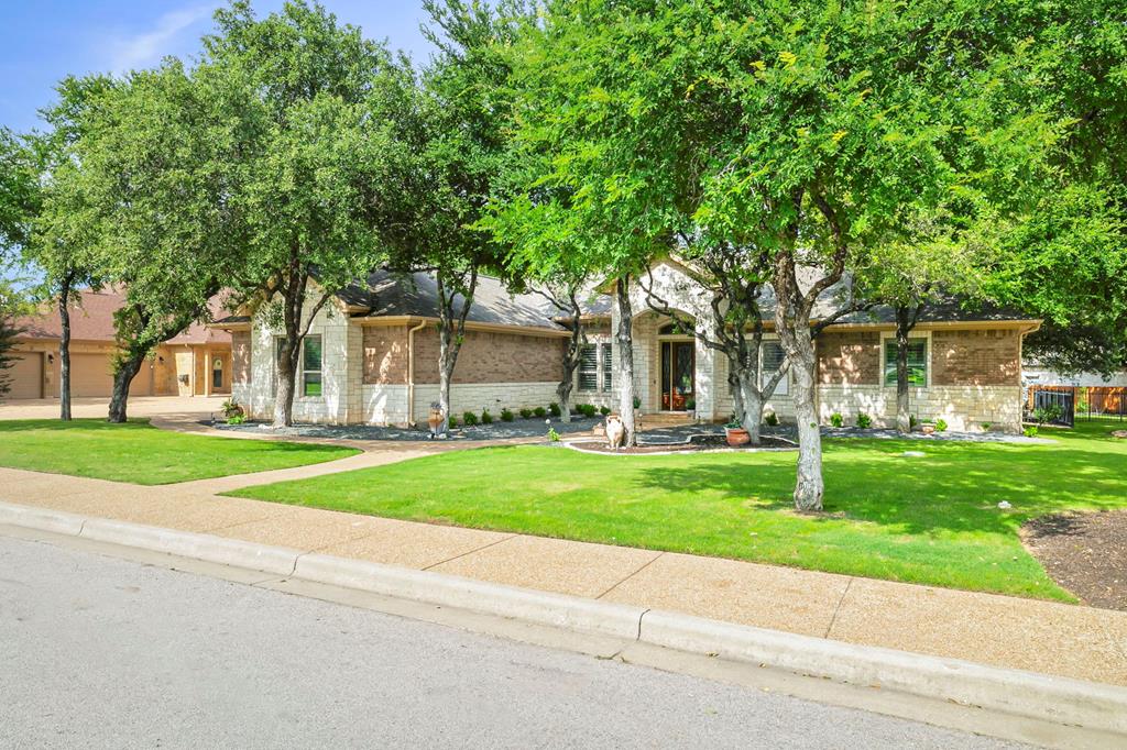 210 Mickelson Lane Georgetown, TX 78628 - Photo 38 of 39 a view of a house with a yard and large trees