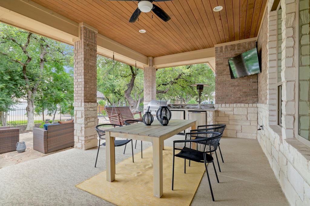 210 Mickelson Lane Georgetown, TX 78628 - Photo 10 of 39 a view of a patio with a table chairs and backyard