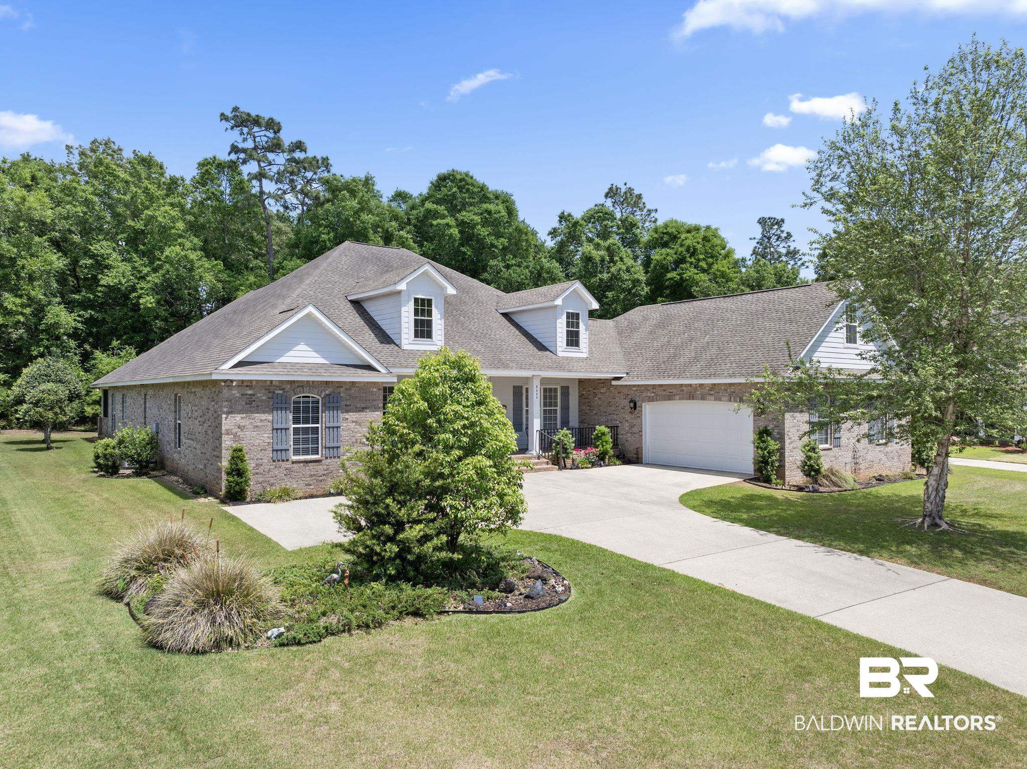 8664 Foxtail Loop Pensacola, FL 32526 - Photo 1 of 64 View of front of house with brick siding, concrete driveway, a garage, a front yard, and a shingled roof