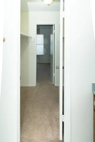 a view of a hallway with wooden floor