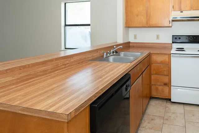 a kitchen with a sink cabinets and a microwave