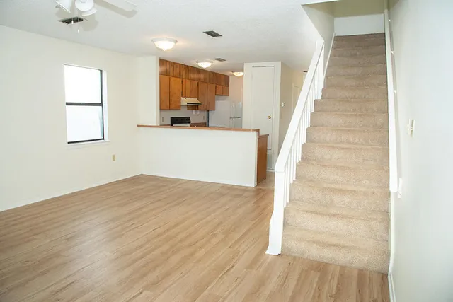 a view of a kitchen with wooden floor and a sink