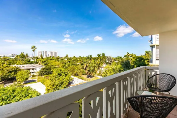 a view of a balcony with wooden floor and outdoor seating