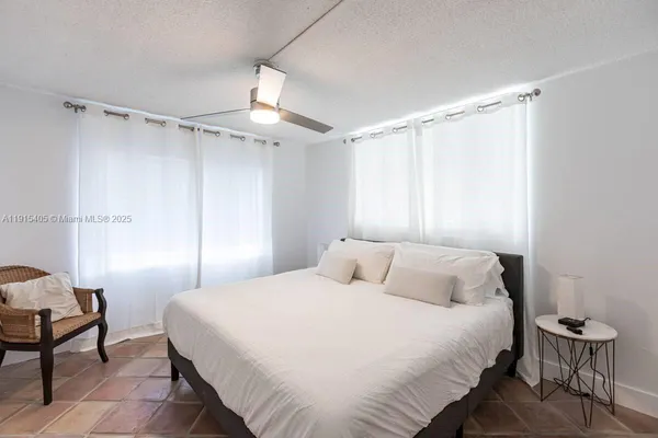 a bedroom with a bed and a chair