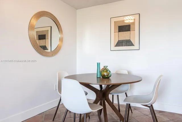 a view of a dining room with furniture and a mirror