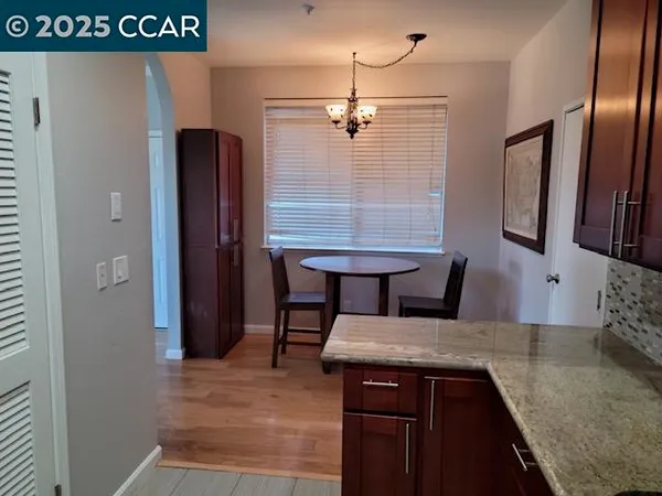 a kitchen with stainless steel appliances granite countertop a sink and a refrigerator