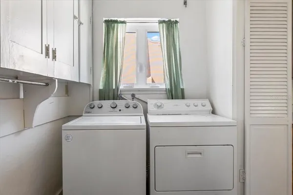 a living room with furniture and a book shelf