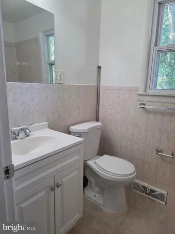 a bathroom with a sink a toilet and window