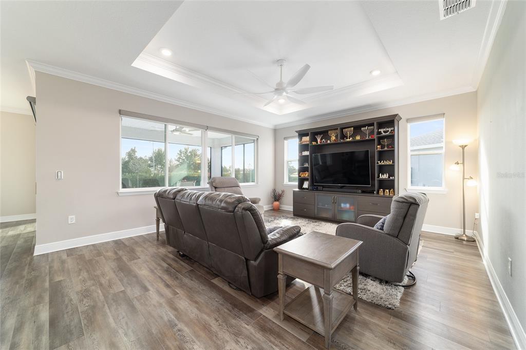 8457 Southwest 97th Circle Ocala, FL 34481 - Photo 12 of 62 a living room with furniture a flat screen tv and a large window