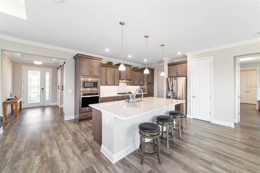 8457 Southwest 97th Circle Ocala, FL 34481 - Photo 21 of 62 a large kitchen with a table and chairs