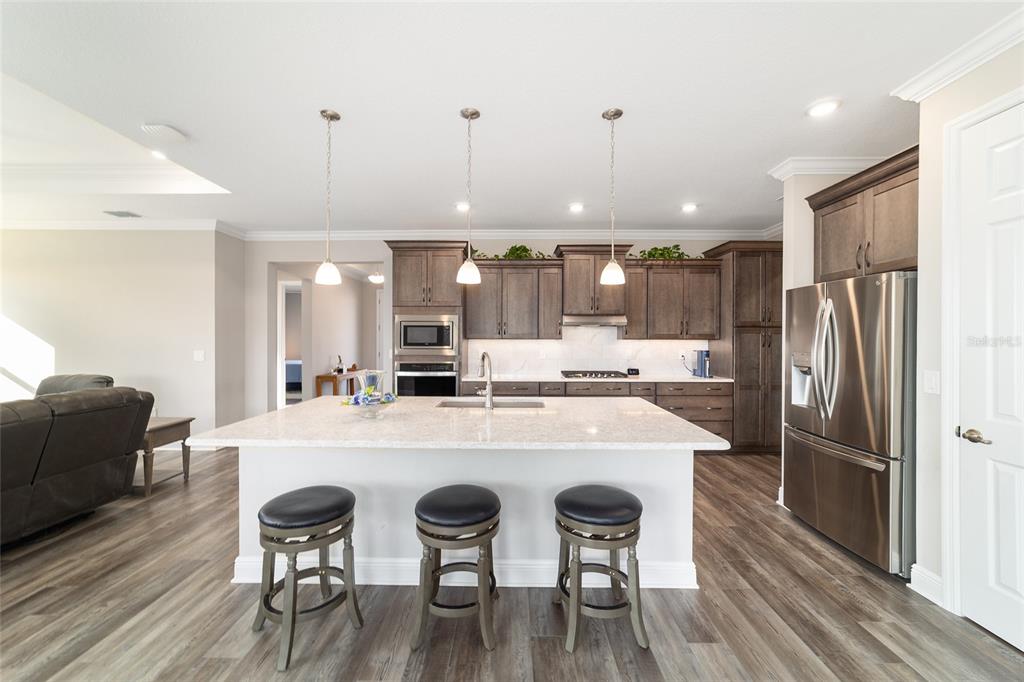8457 Southwest 97th Circle Ocala, FL 34481 - Photo 22 of 62 a large kitchen with a table and chairs