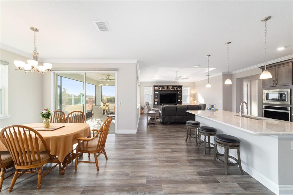 8457 Southwest 97th Circle Ocala, FL 34481 - Photo 24 of 62 a large kitchen with a table and chairs