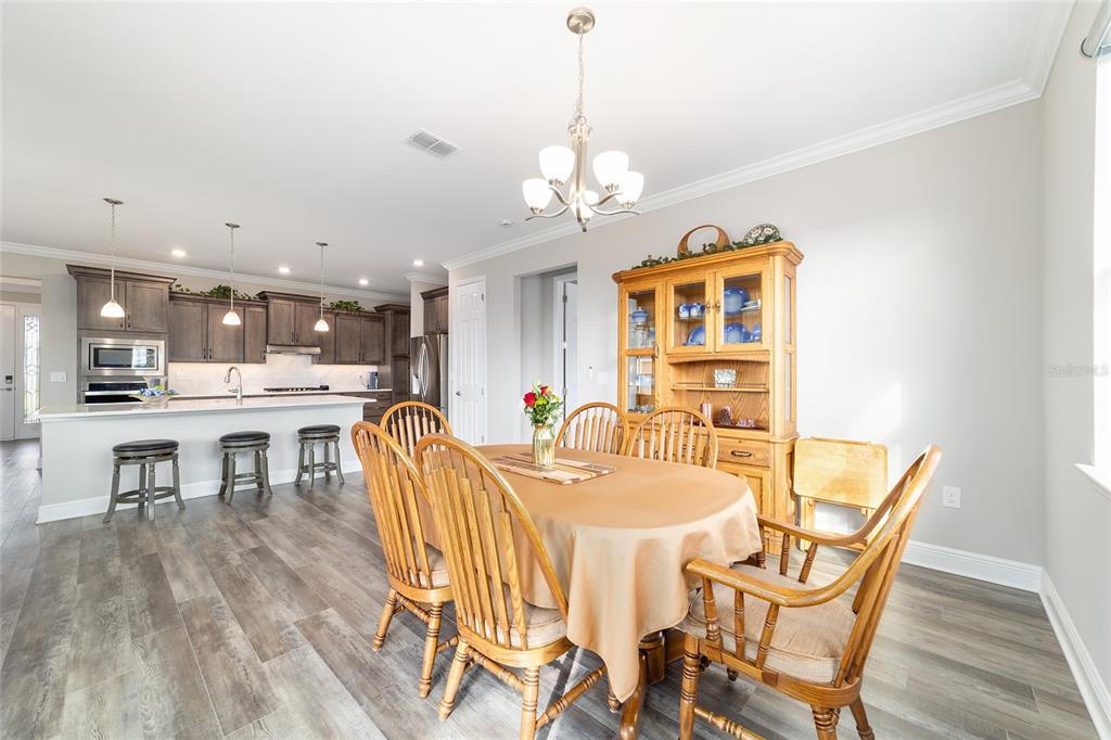 8457 Southwest 97th Circle Ocala, FL 34481 - Photo 31 of 62 a dining room with furniture and wooden floor