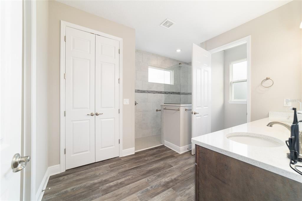 8457 Southwest 97th Circle Ocala, FL 34481 - Photo 37 of 62 a view of a kitchen from the hallway with a sink and wooden floor