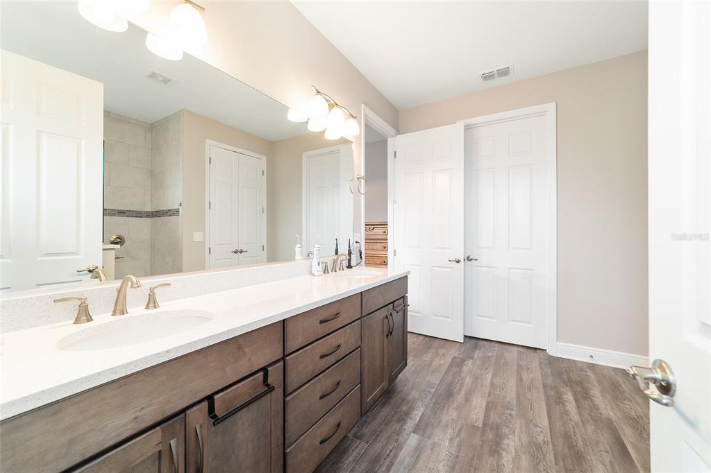8457 Southwest 97th Circle Ocala, FL 34481 - Photo 39 of 62 a bathroom with a double vanity sink and mirror