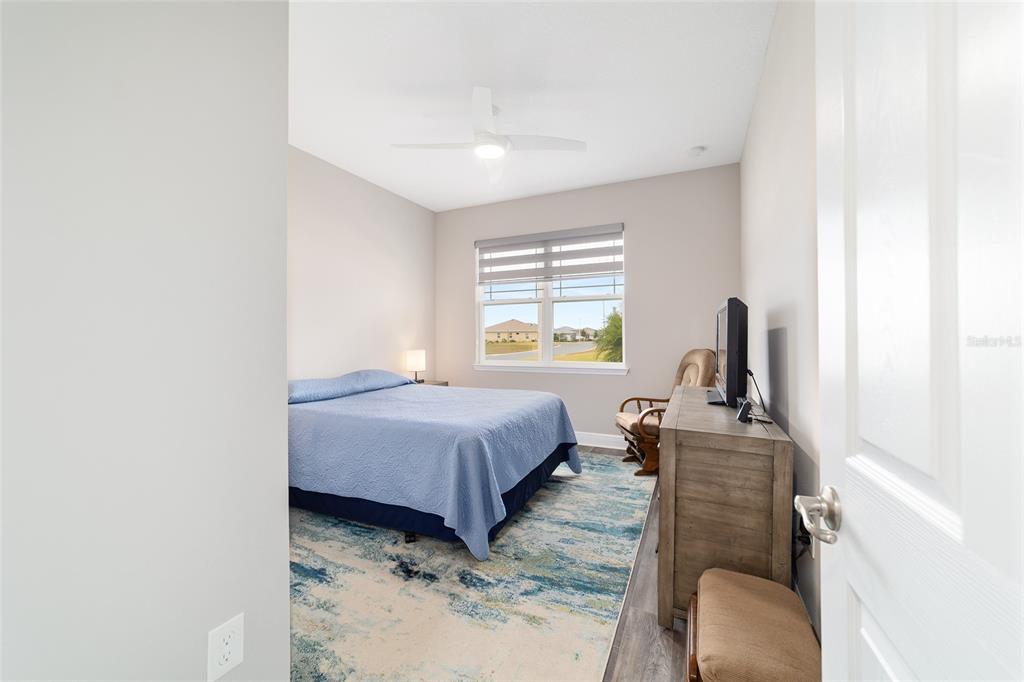 8457 Southwest 97th Circle Ocala, FL 34481 - Photo 49 of 62 a bedroom with a bed and wooden floor