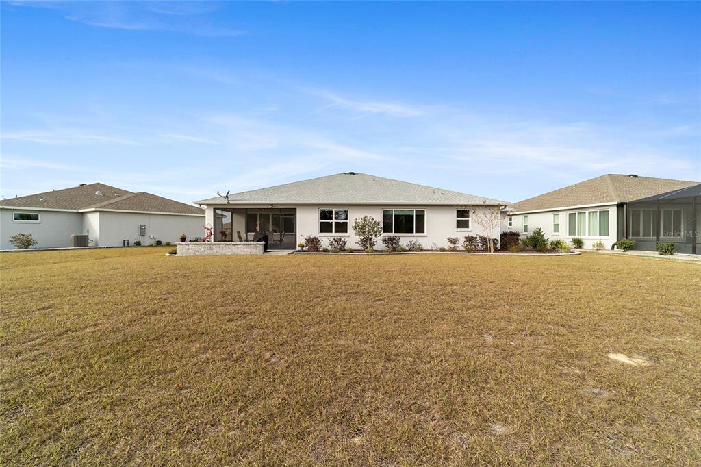 8457 Southwest 97th Circle Ocala, FL 34481 - Photo 62 of 62 a front view of house with yard and trees in the background