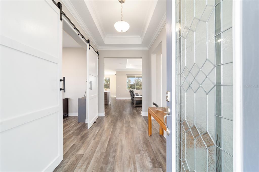 8457 Southwest 97th Circle Ocala, FL 34481 - Photo 9 of 62 a view of a hallway with wooden floor and staircase