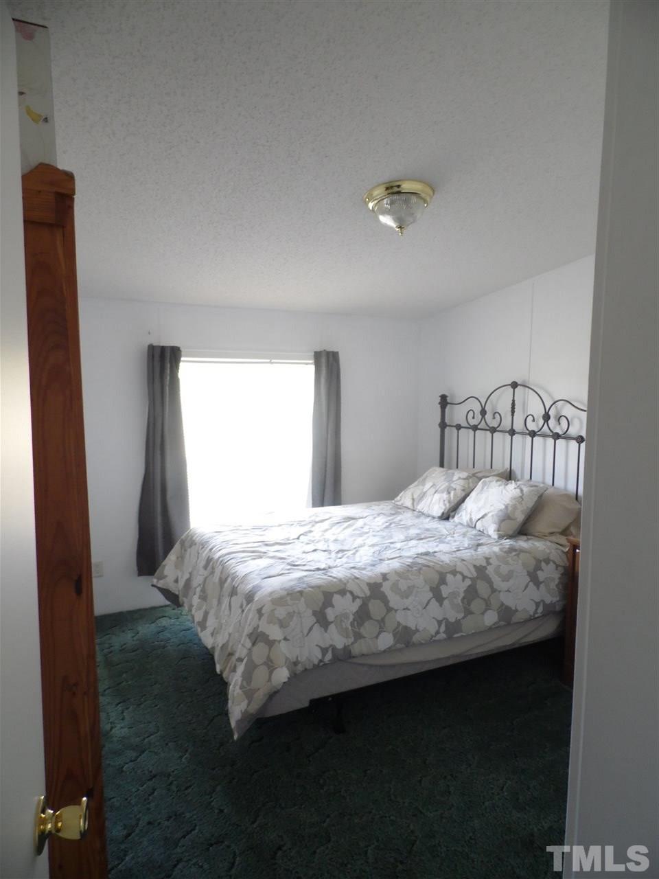 10582 Cone Road Middlesex, NC 27557 - Photo 11 of 25 a bedroom with bed and window