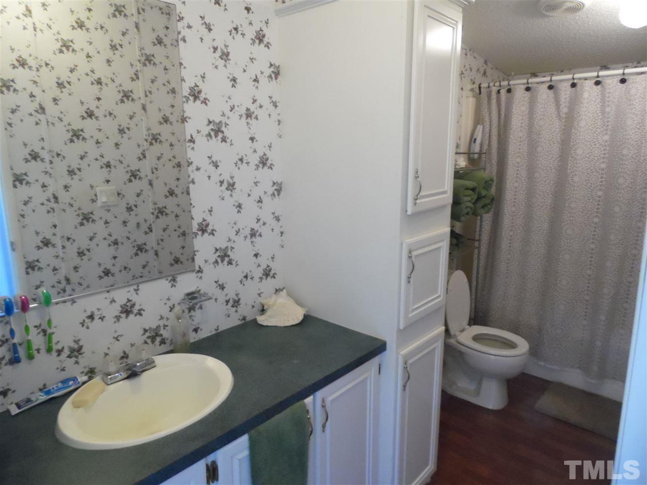 10582 Cone Road Middlesex, NC 27557 - Photo 13 of 25 a bathroom with a sink toilet and a mirror